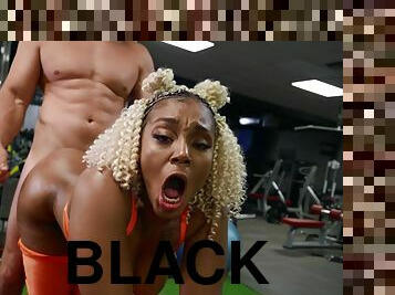 A black curvy gym girl gets boned on all fours by a white guy