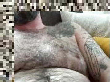 Hairy dad sits back and strokes on the couch, grunting, teasing and edging out a big load