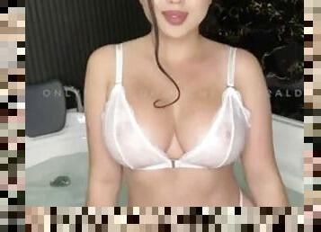 Latina in white lingerie masturbates with a vibrator