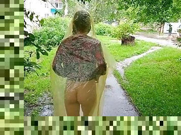 Risky flash of boobs and butt in the rain in a transparent raincoat
