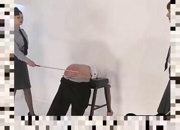 Uniformed bdsm mistresses caning their submissive in trio