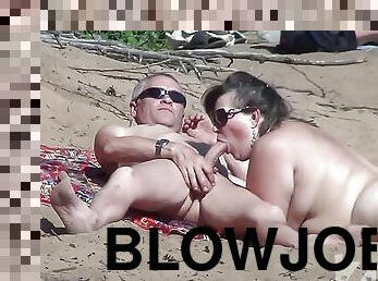 Blowjob on a nudist beach.