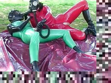 Latex lesbians in a gas mask outdoors