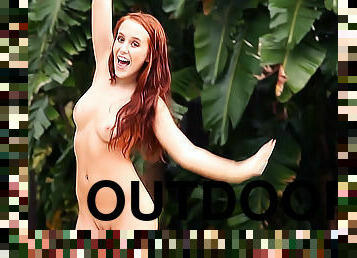 Redhead disrobes outdoors to tease