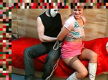 Masked man ties up a pretty girl