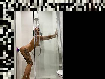 Tattooed teen gril fucking her sex toy in the shower