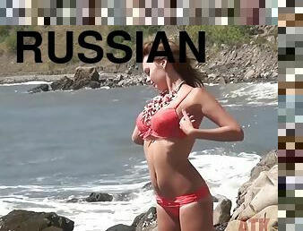 Russian blonde strips naked on the beach