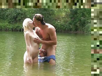 German couple having outdoor sex with a blowjob in the lake