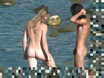 Two babes are posing naked on the beach