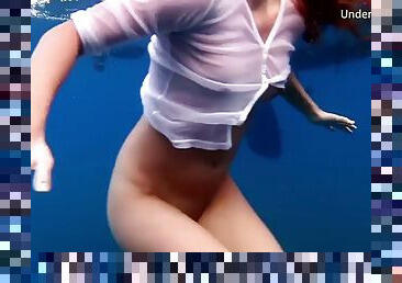 A girl from Tenerife swims naked underwater