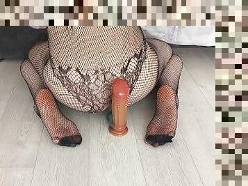 Sissy in a bodystocking riding monster dildo