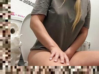 girl pissing over the toilet at home