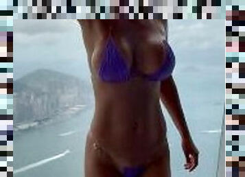 Monika Fox In Purple Bikini Swims In Pool & Poses By Window Against Background Of City